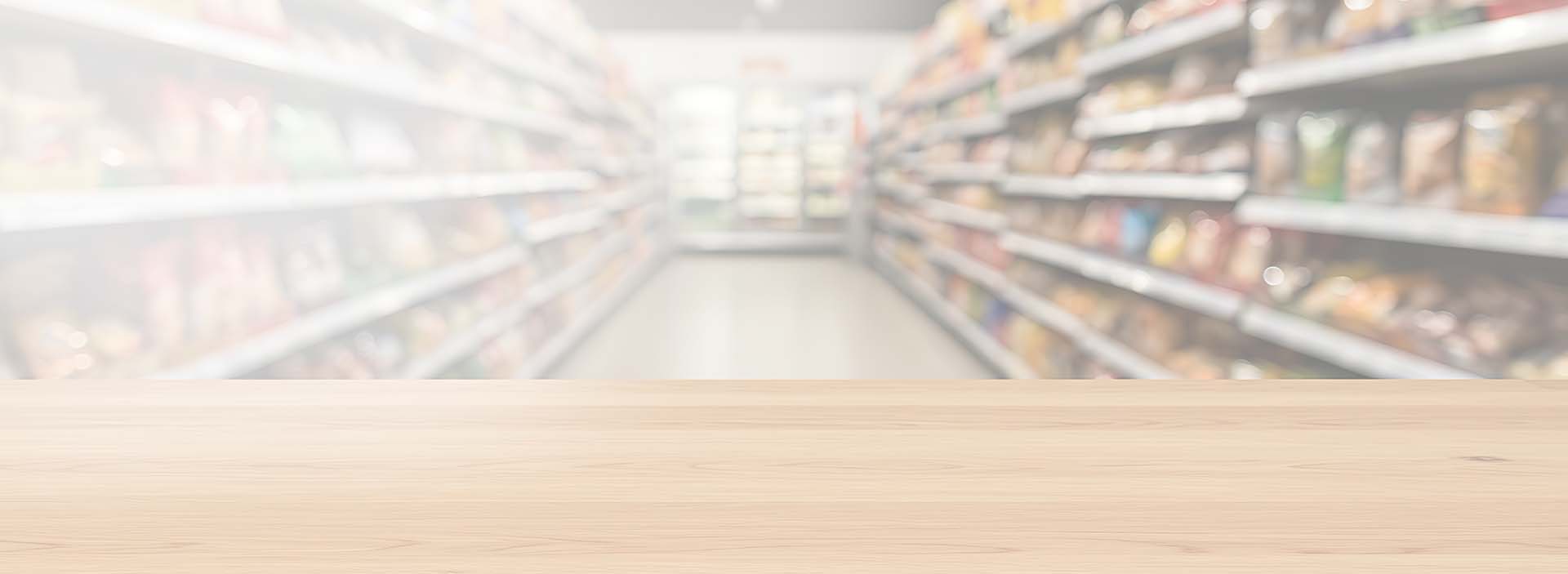 Fondo de banner de Rapitienda Mona mostrando pasillo de minimarket con productos y ofertas.